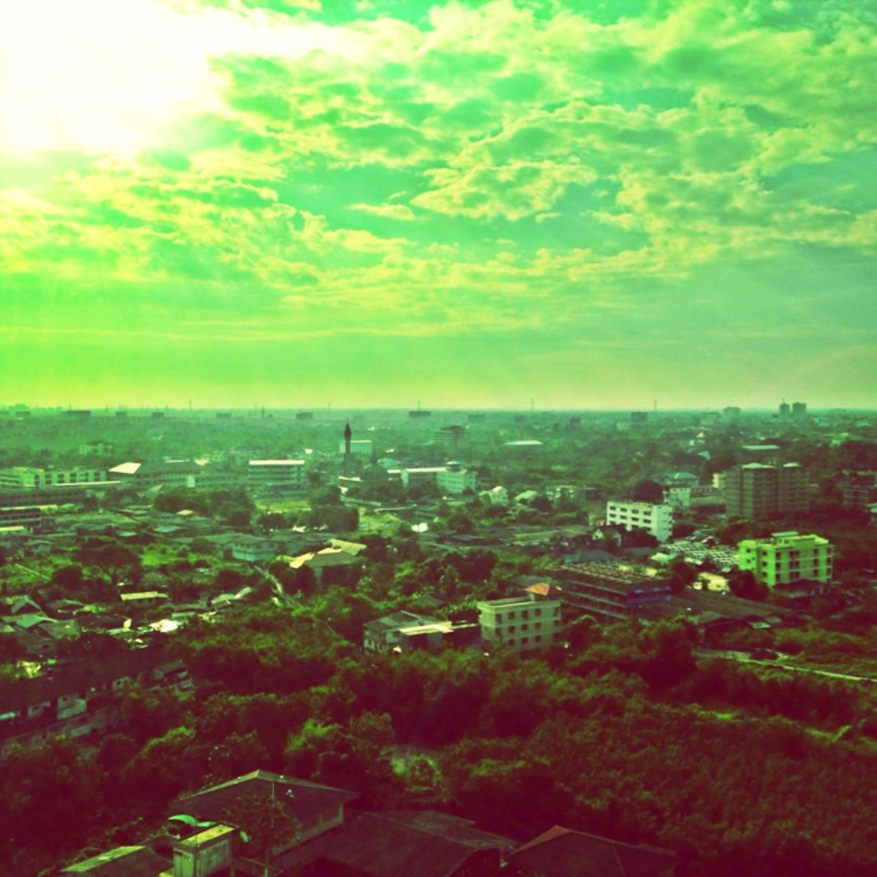 building exterior, architecture, sky, cityscape, built structure, high angle view, city, landscape, cloud - sky, residential district, crowded, aerial view, residential building, nature, scenics, green color, tree, residential structure, beauty in nature, sunset