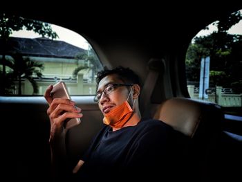 Man using phone while sitting in car