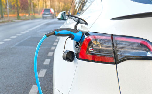 Electric vehicle charging at public charging station. new energy vehicles, alternative energy