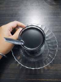 High angle view of person preparing tea on table