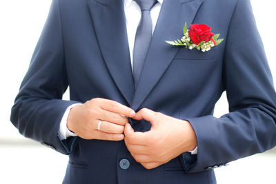 Midsection of man holding flower