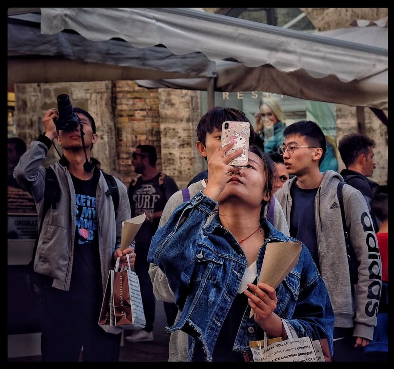 PEOPLE LOOKING AT MARKET STALL