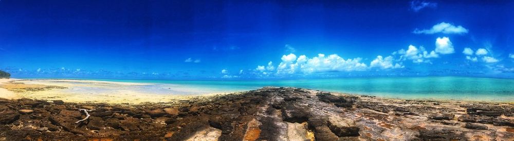 Panoramic view of sea against blue sky