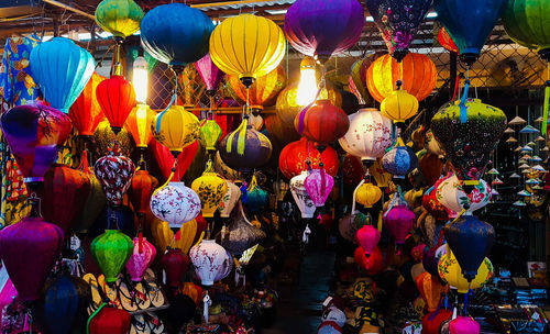 Multi colored lanterns hanging for sale at market stall