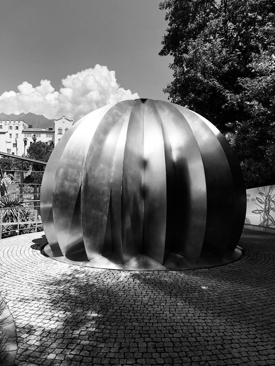 CLOSE-UP OF METALLIC STRUCTURE AGAINST BUILDING