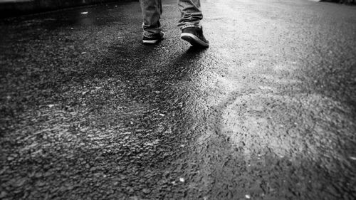 Low section of woman walking on road