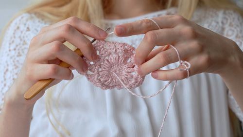 Midsection of woman holding wedding dress
