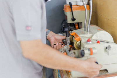 Midsection of man working in workshop