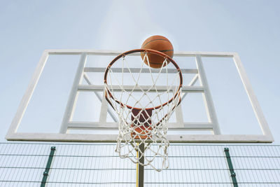 Basketball goes through the hoop on the sports field