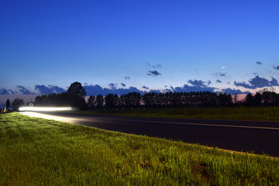 Scenic view of field against blue sky