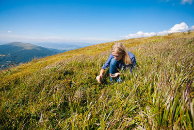 Woman on field against sky