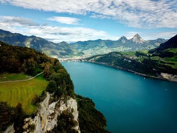 Scenic view of lake and mountains against sky