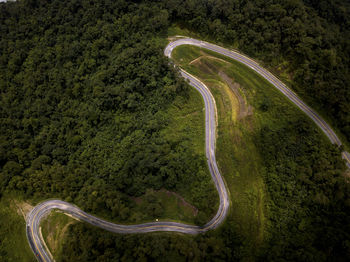 Aerial view of countryside road on the lush greenery tropical rain forest mountain landscape