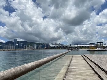 Pier by sea against sky in city