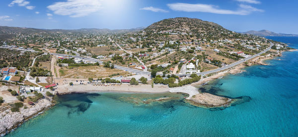 High angle view of townscape by sea against sky