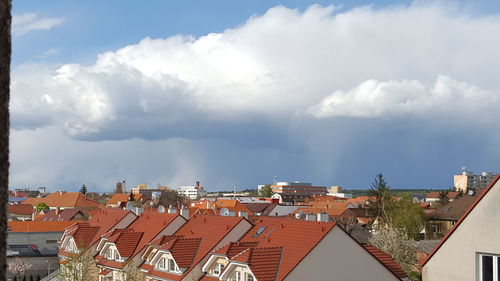 Residential buildings against cloudy sky