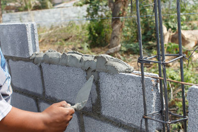 Close-up of man working on concrete