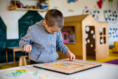 Boy playing on table at home