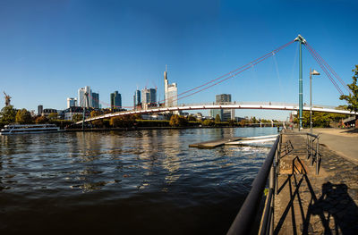 Bridge over river with city in background