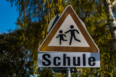 Close-up of road sign against trees