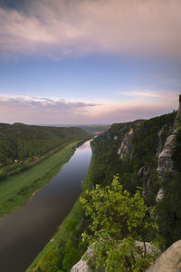 Scenic view of river amidst mountains against sky