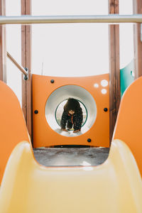 Girl playing on slide at playground