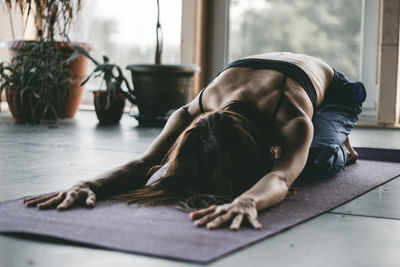 Midsection of woman lying down on floor