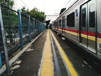 Train on railroad station platform against sky