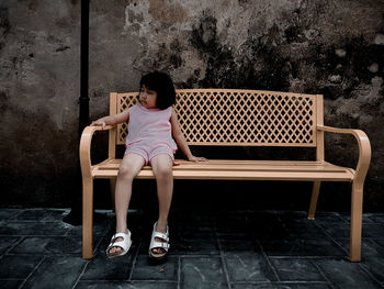 Full length of girl sitting on floor