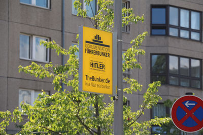 Low angle view of information sign against building