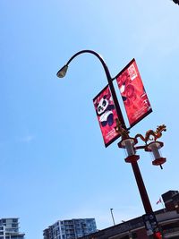 Low angle view of street light against clear blue sky