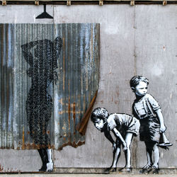 Statue of woman standing against wall