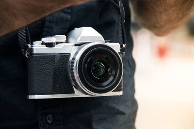 Close-up of man photographing camera