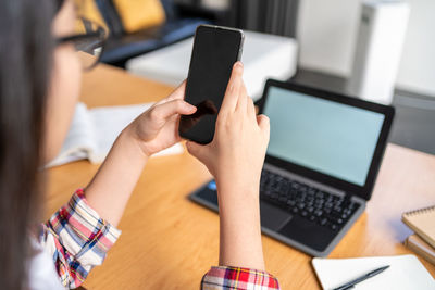 Midsection of woman using mobile phone