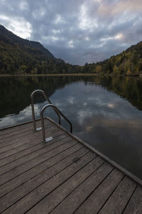 Pier on lake against sky