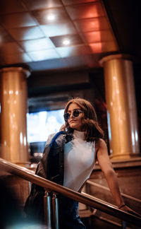 Woman standing by railing