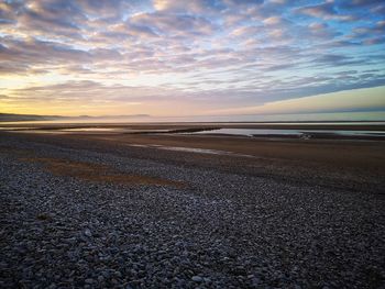 Scenic view of beach against sky during sunset