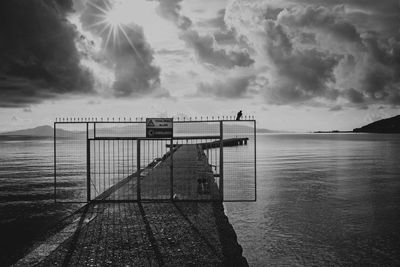 Pier over sea against sky