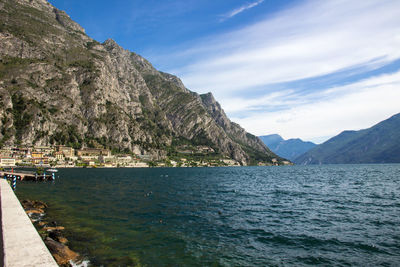 Scenic view of sea and mountains against sky