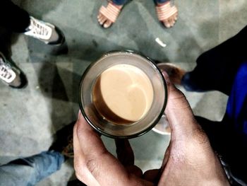 High angle view of man holding coffee cup