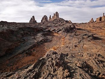 Rock formation on land against sky