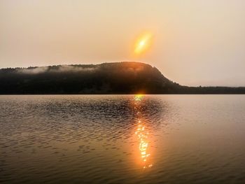 Scenic view of lake at sunset