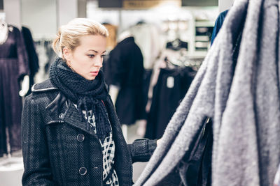 Portrait of young woman standing in store