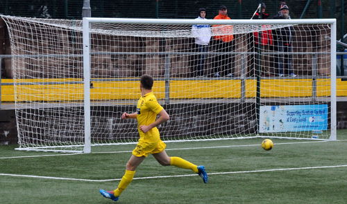 Full length of man playing soccer ball