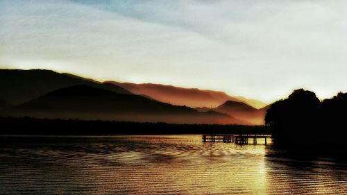 Scenic view of lake at sunset