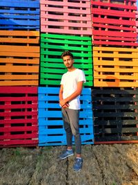 Portrait of young man standing against built structure