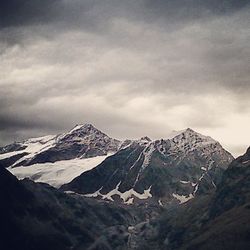 Scenic view of mountains against cloudy sky