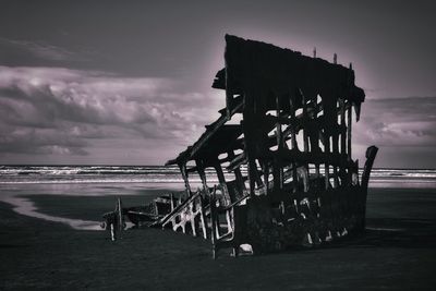 Pier over sea against sky during sunset