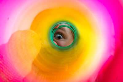 Child's eye through a colorful slinky