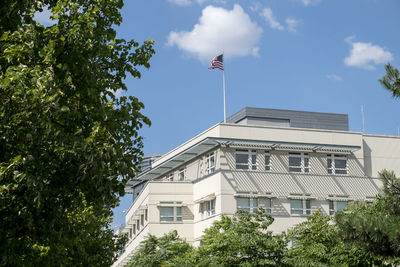 Trees against american flag on building